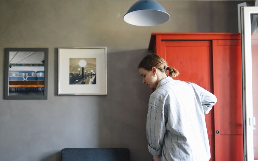 Cleaner mopping a bright living room floor