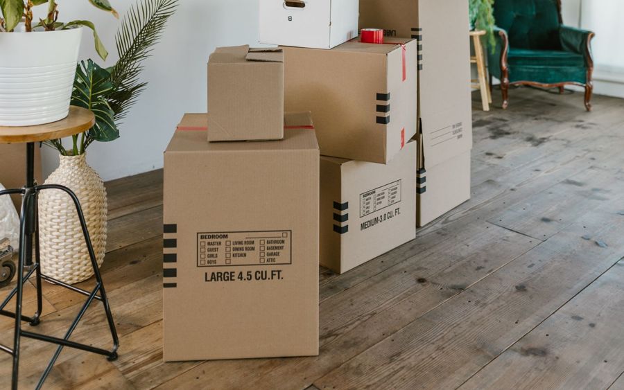 Moving boxes in a bright, freshly cleaned empty room
